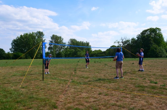 Players ready on both sides of the outdoor net
