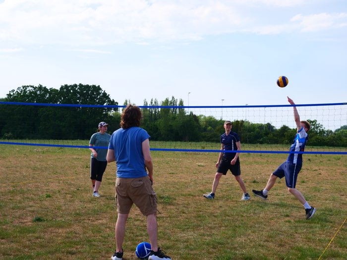 A player leaping for a spike at the net